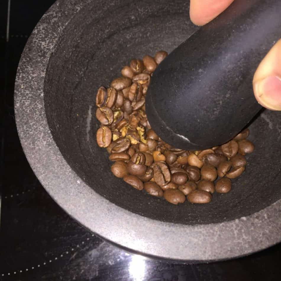 Grinding coffee with a mortar and pestle